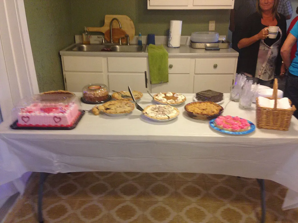 Dessert table with cakes, pies, and cookies prepared for a guest celebration at Amigo Inn
