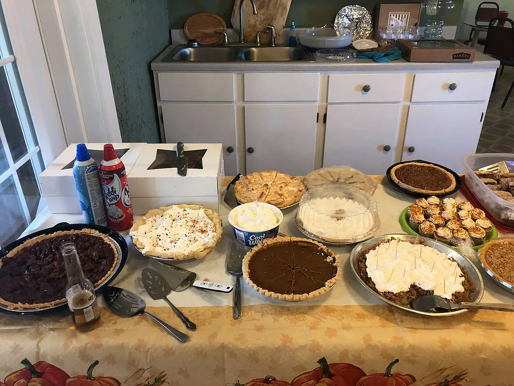 Assorted pies and desserts arranged on a table for a guest celebration at Amigo Inn